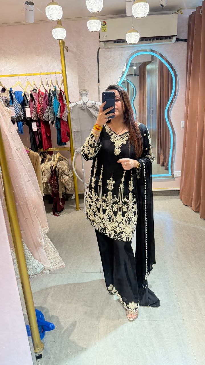 Pakistani-style heavy embroidered georgette palazzo suit set.