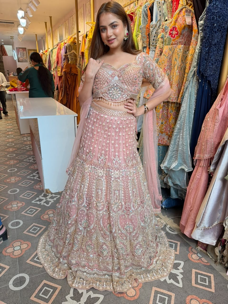 Blush Pink heavily embellished flared lehenga and matching blouse.