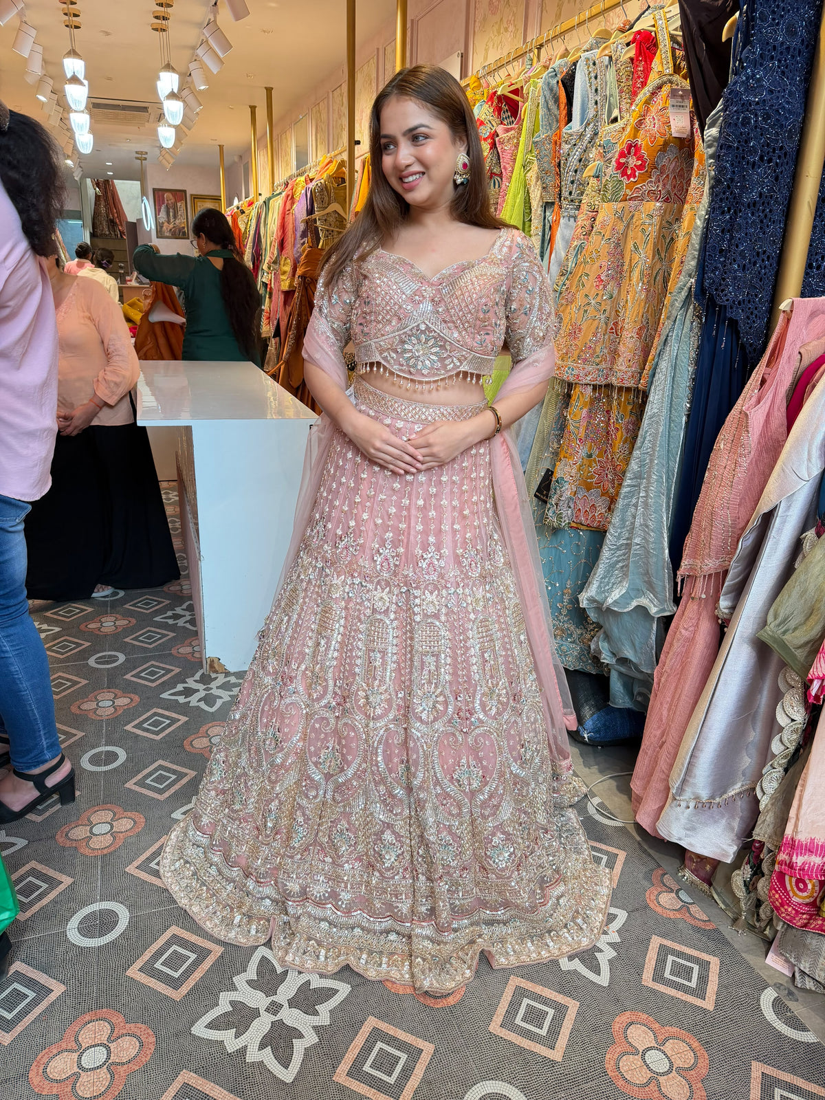 Blush Pink heavily embellished flared lehenga and matching blouse.