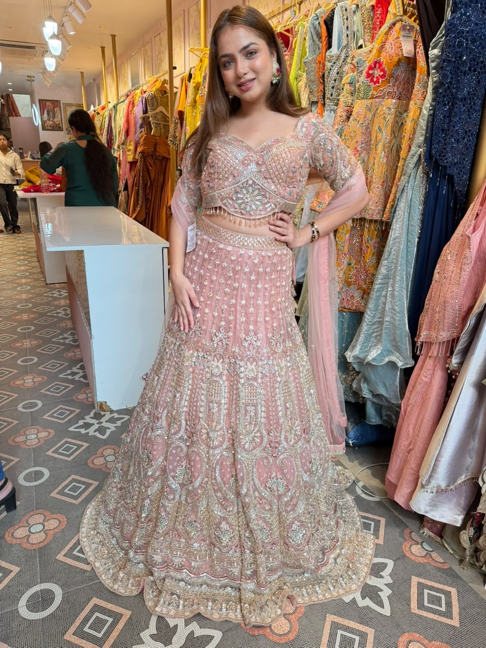 Blush Pink heavily embellished flared lehenga and matching blouse.